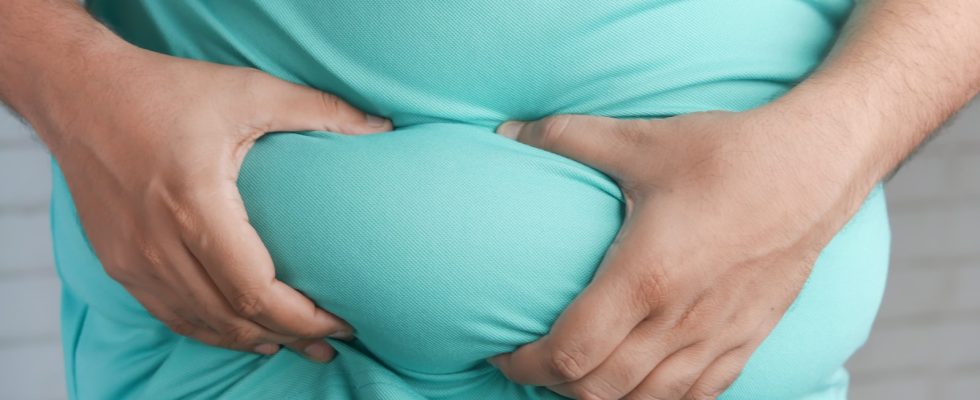 a man holding his stomach with his hands